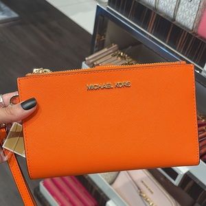Neon Orange Michael Kors Wallet with cell phone slot. NWT